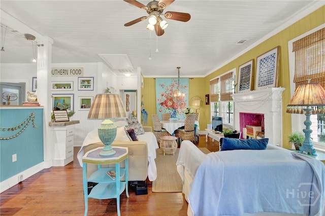 14 Bright St, Tybee Island, GA 31328 - living room featuring crown molding, ceiling fan, wood finished floors, a high end fireplace, and attic access