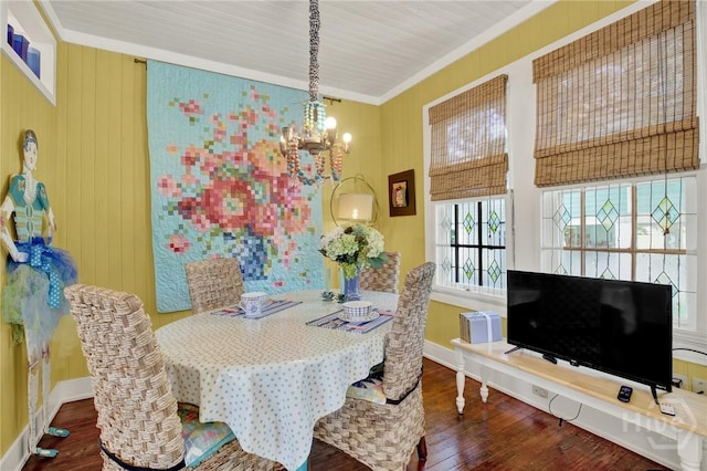 14 Bright St, Tybee Island, GA 31328 - dining space featuring a chandelier, wood-type flooring, ornamental molding, and baseboards