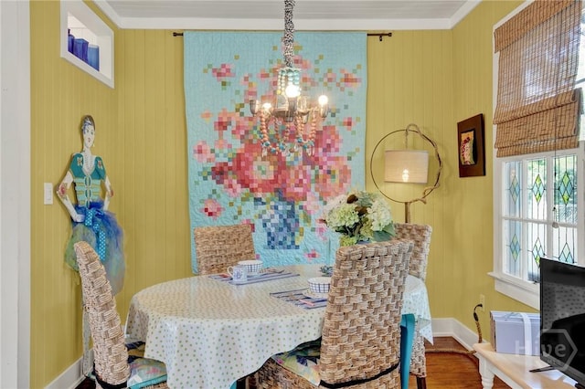 14 Bright St, Tybee Island, GA 31328 - dining room featuring a chandelier, wood finished floors, baseboards, and crown molding