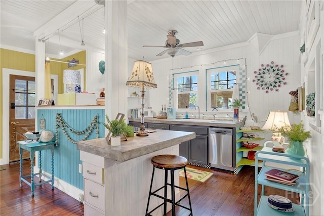 14 Bright St, Tybee Island, GA 31328 - kitchen with dark wood-style flooring, stainless steel dishwasher, a sink, crown molding, and a kitchen bar