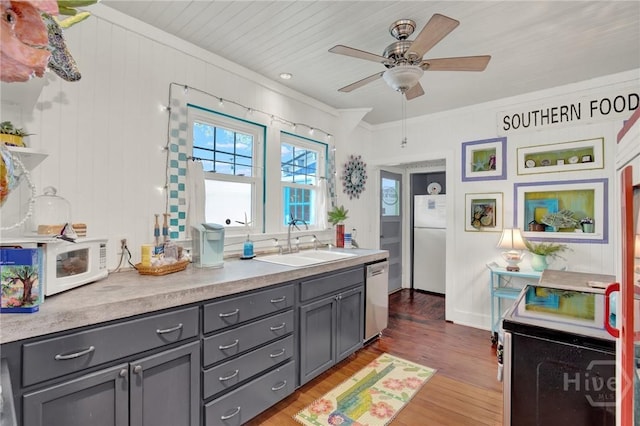 14 Bright St, Tybee Island, GA 31328 - kitchen with gray cabinetry, white appliances, a sink, ornamental molding, and light wood finished floors