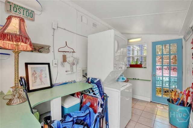 14 Bright St, Tybee Island, GA 31328 - laundry room featuring estacked washer and dryer and light tile patterned flooring