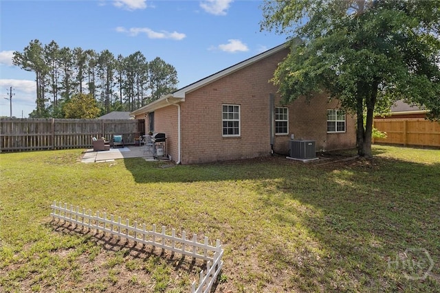 2000 Ossabaw Dr, Hinesville, GA 31313 - back of house featuring a patio area, brick siding, and central air condition unit