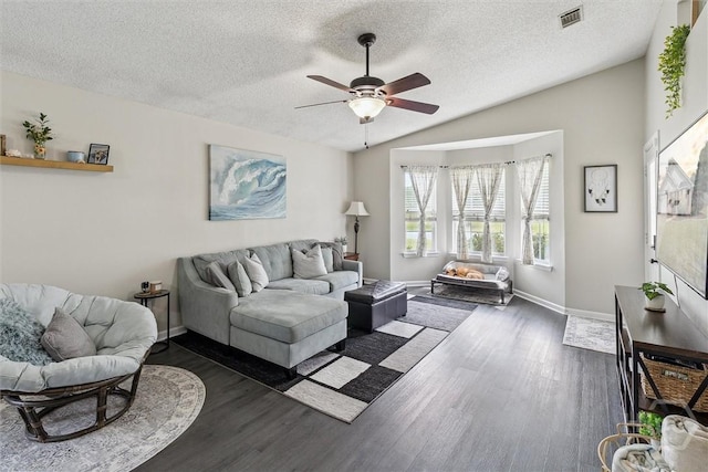 2000 Ossabaw Dr, Hinesville, GA 31313 - living area featuring dark wood-style flooring, ceiling fan, a textured ceiling, baseboards, and lofted ceiling