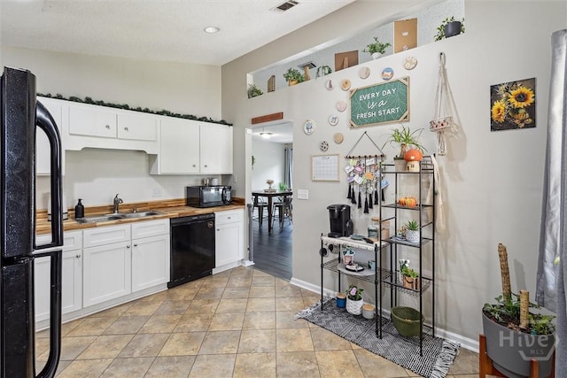2000 Ossabaw Dr, Hinesville, GA 31313 - kitchen featuring black appliances, a sink, wooden counters, white cabinets, and baseboards