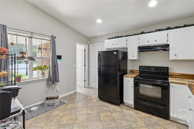 2000 Ossabaw Dr, Hinesville, GA 31313 - kitchen featuring black appliances, under cabinet range hood, wooden counters, white cabinetry, and vaulted ceiling