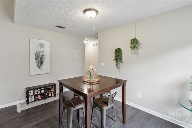 2000 Ossabaw Dr, Hinesville, GA 31313 - dining area featuring dark wood-type flooring, baseboards, and a textured ceiling