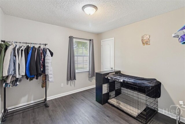 2000 Ossabaw Dr, Hinesville, GA 31313 - bathroom with wood finished floors, a textured ceiling, and baseboards