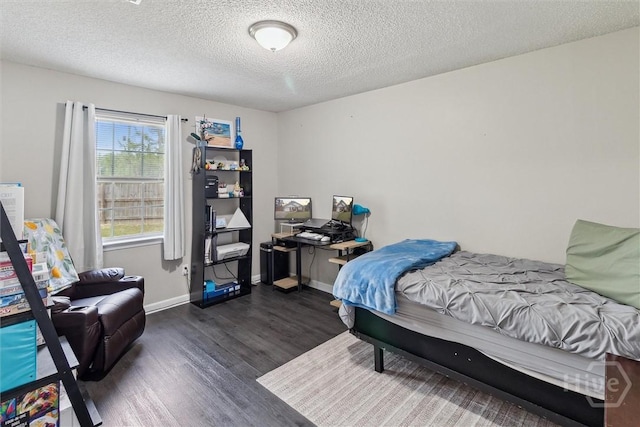 2000 Ossabaw Dr, Hinesville, GA 31313 - bedroom featuring wood finished floors, a textured ceiling, and baseboards