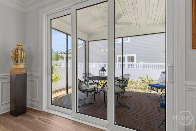 117 Quince St, Pooler, GA 31322 - doorway to outside with wood finished floors, a decorative wall, crown molding, and a wainscoted wall