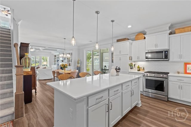 117 Quince St, Pooler, GA 31322 - kitchen with appliances with stainless steel finishes, wood finished floors, light countertops, plenty of natural light, and ornamental molding