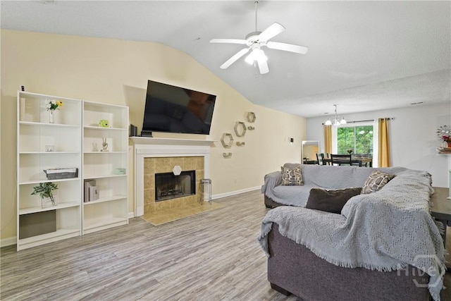21 Hawser Way, Port Wentworth, GA 31407 - living area featuring vaulted ceiling, wood finished floors, a chandelier, a ceiling fan, and a tile fireplace