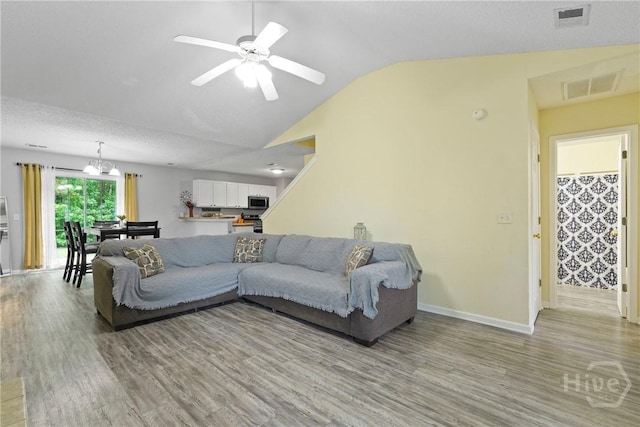 21 Hawser Way, Port Wentworth, GA 31407 - living area with light wood finished floors, lofted ceiling, baseboards, ceiling fan, and a chandelier