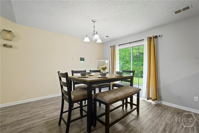 21 Hawser Way, Port Wentworth, GA 31407 - dining area featuring a chandelier, dark wood finished floors, a textured ceiling, and baseboards