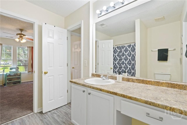 21 Hawser Way, Port Wentworth, GA 31407 - bathroom featuring a textured ceiling, vanity, wood finished floors, a ceiling fan, and toilet