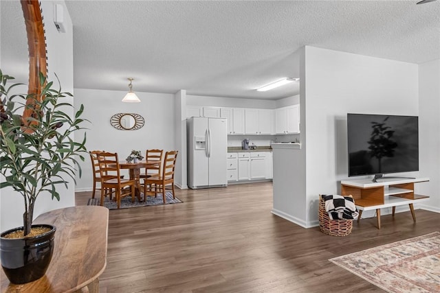 231 Tigers Paw Dr, Pooler, GA 31322 - living area featuring a textured ceiling, wood finished floors, and baseboards