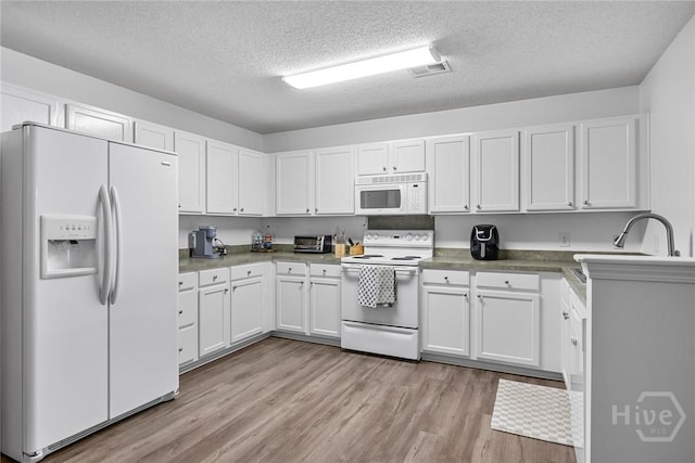 231 Tigers Paw Dr, Pooler, GA 31322 - kitchen with white appliances, light wood-type flooring, white cabinets, and a textured ceiling