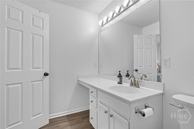 231 Tigers Paw Dr, Pooler, GA 31322 - bathroom featuring vanity, toilet, a textured ceiling, wood finished floors, and baseboards