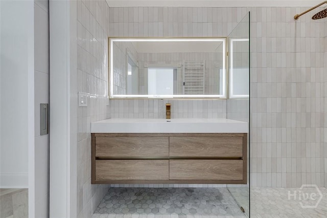 316 W 38th St, Savannah, GA 31401 - bathroom with tile walls, a tile shower, vanity, and tile patterned flooring
