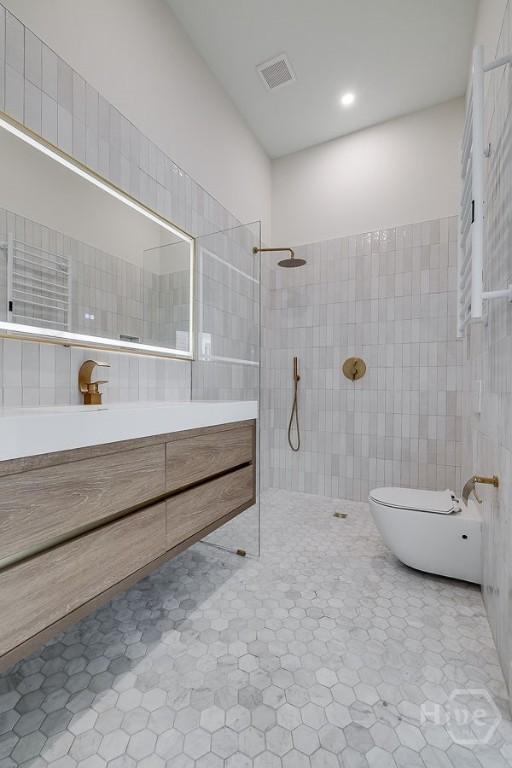 316 W 38th St, Savannah, GA 31401 - full bathroom featuring vanity, a walk in shower, tile walls, toilet, and a bidet