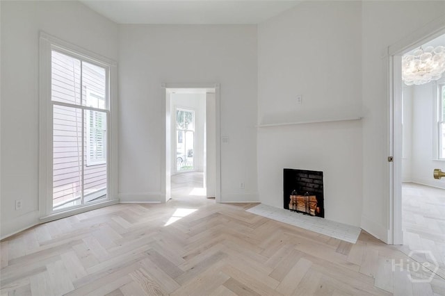 316 W 38th St, Savannah, GA 31401 - unfurnished living room featuring a fireplace with flush hearth and baseboards