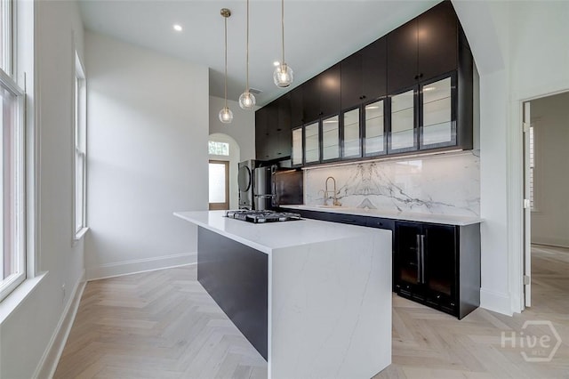 316 W 38th St, Savannah, GA 31401 - kitchen featuring stainless steel gas cooktop, baseboards, backsplash, light countertops, and a kitchen island