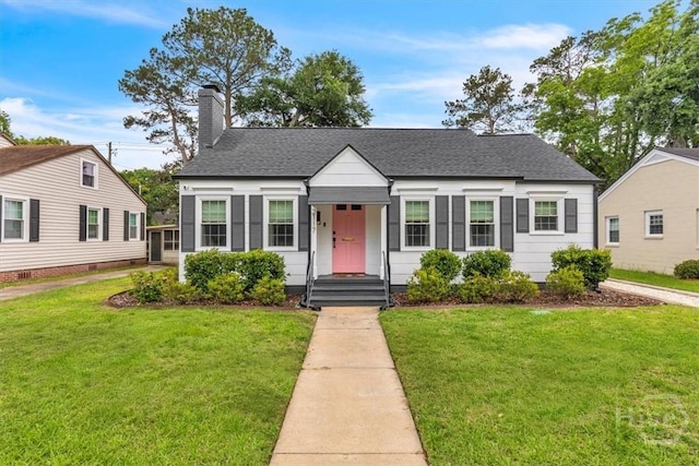 2117 E 42nd St, Savannah, GA 31404 - view of front of property featuring roof with shingles, a front lawn, and a chimney