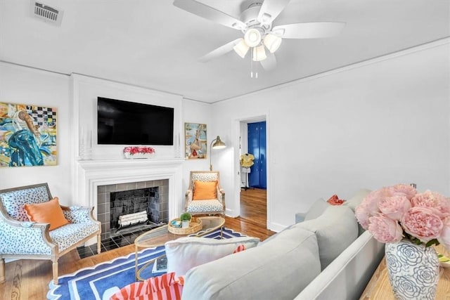 2117 E 42nd St, Savannah, GA 31404 - living area featuring wood finished floors, a ceiling fan, a fireplace, and baseboards