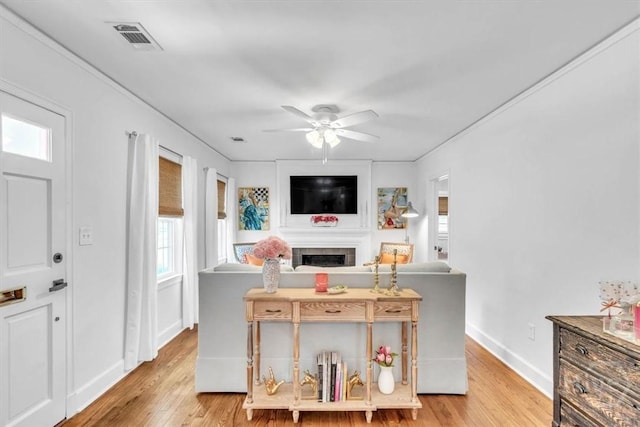 2117 E 42nd St, Savannah, GA 31404 - living room featuring healthy amount of natural light, light wood finished floors, ceiling fan, and a fireplace