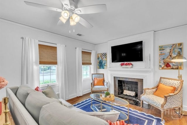 2117 E 42nd St, Savannah, GA 31404 - living room featuring wood finished floors, ceiling fan, a fireplace, and baseboards