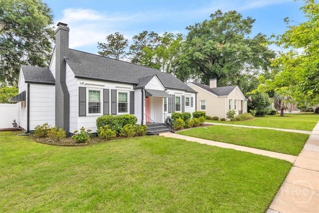 2117 E 42nd St, Savannah, GA 31404 - view of front facade featuring a shingled roof and a chimney