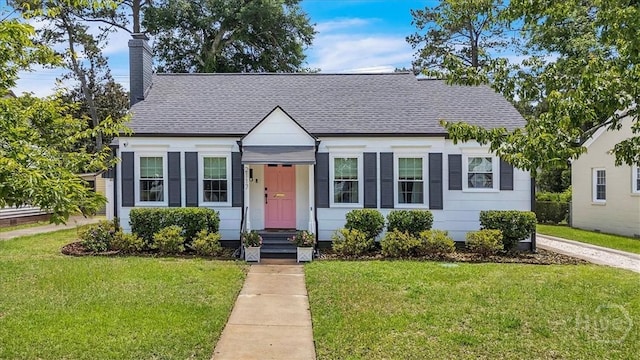 2117 E 42nd St, Savannah, GA 31404 - view of front facade with a front lawn, a chimney, and a shingled roof