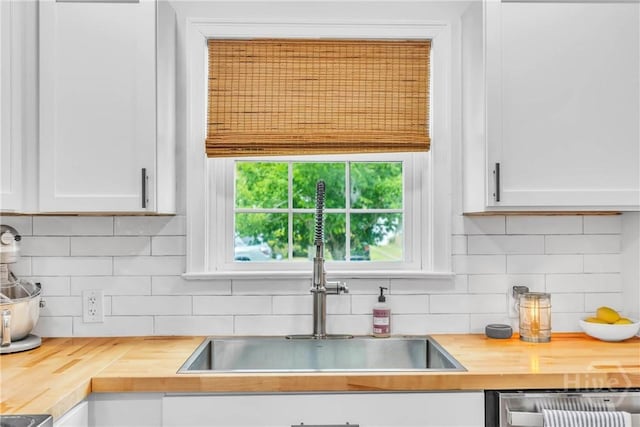 2117 E 42nd St, Savannah, GA 31404 - kitchen featuring wooden counters, a sink, dishwasher, white cabinetry, and tasteful backsplash