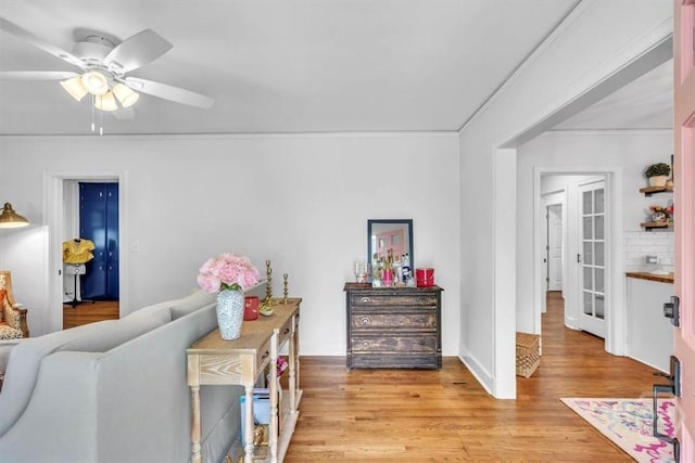 2117 E 42nd St, Savannah, GA 31404 - living area featuring light wood finished floors, a ceiling fan, and ornamental molding
