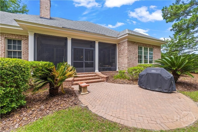 312 Spanton, Pooler, GA 31322 - back of house with brick siding, a patio, a sunroom, a chimney, and roof with shingles