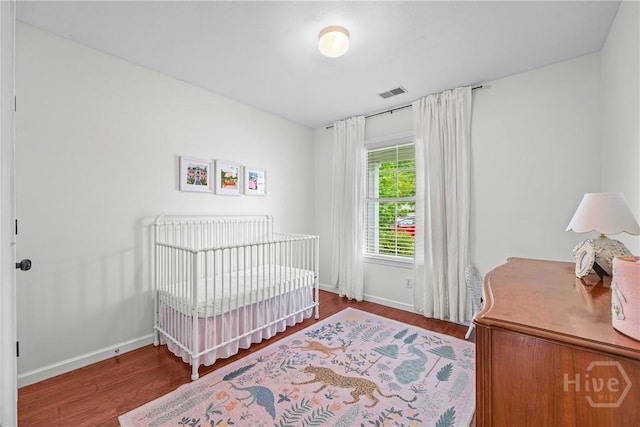 1 Westbourne Way, Savannah, GA 31407 - bedroom with wood finished floors, baseboards, and a crib
