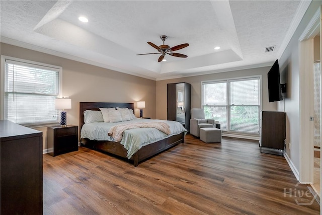 103 W Gazebo Ln, Savannah, GA 31410 - bedroom with a tray ceiling, a textured ceiling, dark wood-style flooring, crown molding, and baseboards