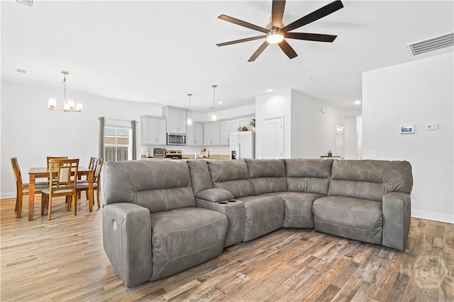 208 Cherokee Oaks Xing, Hinesville, GA 31313 - living area with ceiling fan, light wood-type flooring, a chandelier, baseboards, and recessed lighting