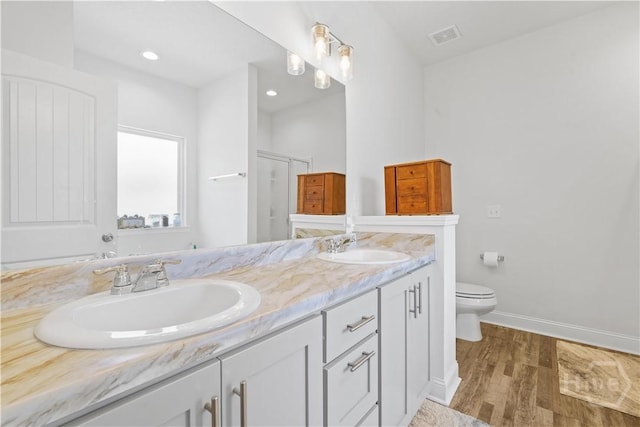 208 Cherokee Oaks Xing, Hinesville, GA 31313 - full bath with double vanity, toilet, baseboards, wood finished floors, and a shower with shower door