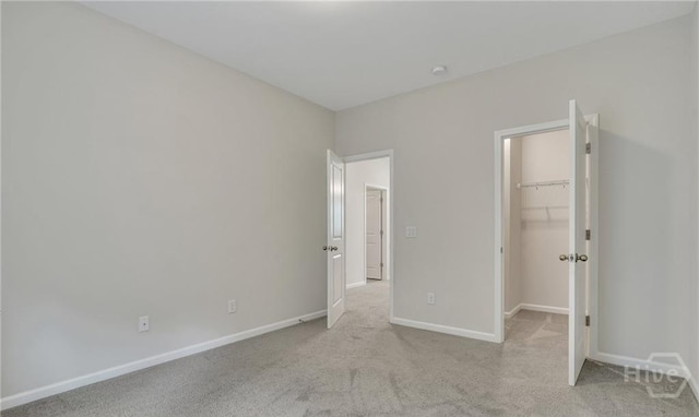 20 Lower Creek Dr, Richmond Hill, GA 31324 - unfurnished bedroom with a walk in closet, carpet, baseboards, and a closet