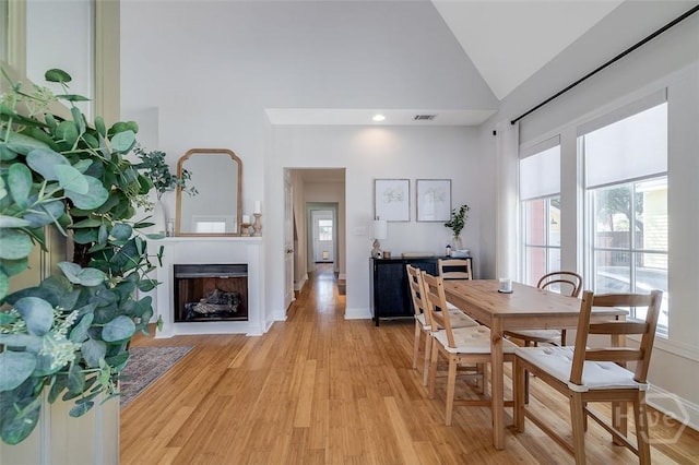 115 Daisy Ct, Savannah, GA 31404 - dining space featuring plenty of natural light, light wood finished floors, high vaulted ceiling, and baseboards