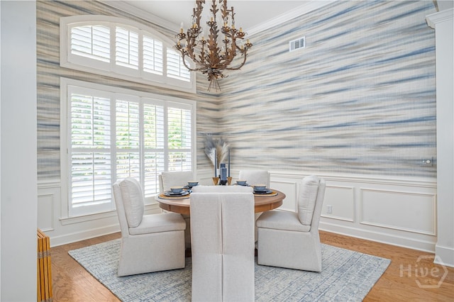 16 Middleton Rd, Savannah, GA 31411 - dining area featuring wallpapered walls, a chandelier, a wainscoted wall, an office area, and wood finished floors