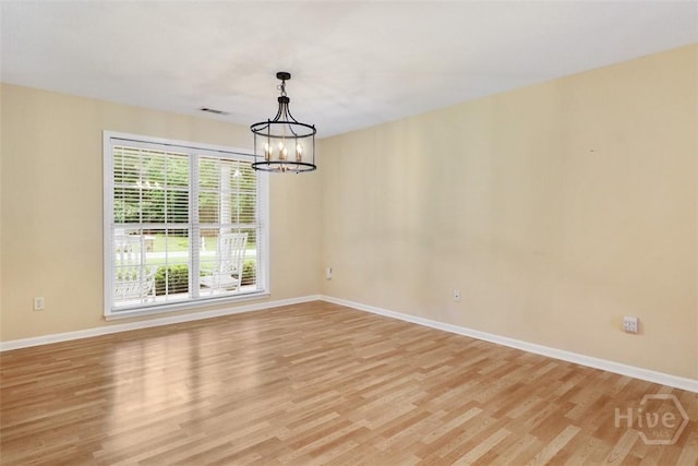 101 Coldbrook Cir, Rincon, GA 31326 - empty room with light wood-style floors, a chandelier, and baseboards