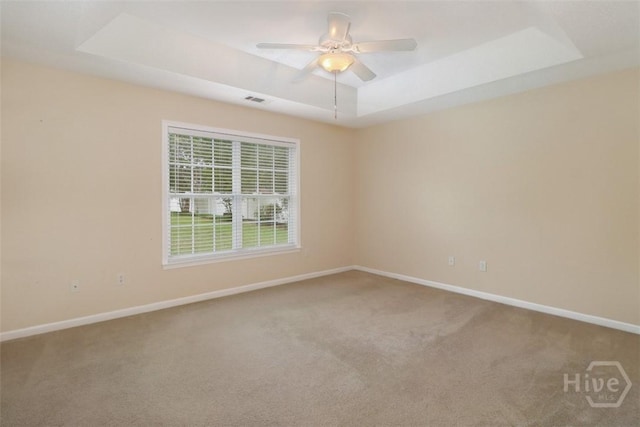 101 Coldbrook Cir, Rincon, GA 31326 - carpeted empty room with a tray ceiling, baseboards, and ceiling fan