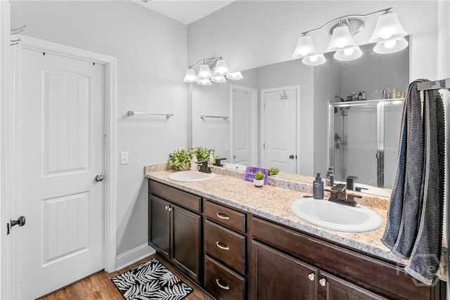 402 Abode Ave, Hinesville, GA 31313 - full bath featuring double vanity, a stall shower, wood finished floors, and baseboards