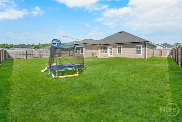 402 Abode Ave, Hinesville, GA 31313 - rear view of property with a trampoline and roof with shingles