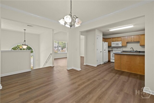 303 Aspen, Rincon, GA 31326 - kitchen with white appliances, dark countertops, a chandelier, open floor plan, and ornamental molding