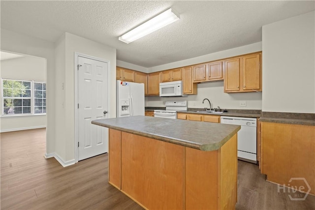 303 Aspen, Rincon, GA 31326 - kitchen featuring white appliances, a sink, dark wood-type flooring, a textured ceiling, and dark countertops