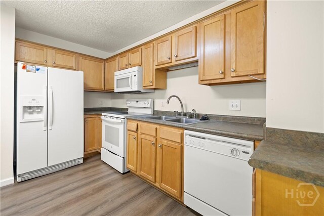 303 Aspen, Rincon, GA 31326 - kitchen with white appliances, a sink, dark countertops, light wood finished floors, and a textured ceiling