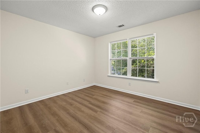 303 Aspen, Rincon, GA 31326 - empty room with wood finished floors, baseboards, and a textured ceiling